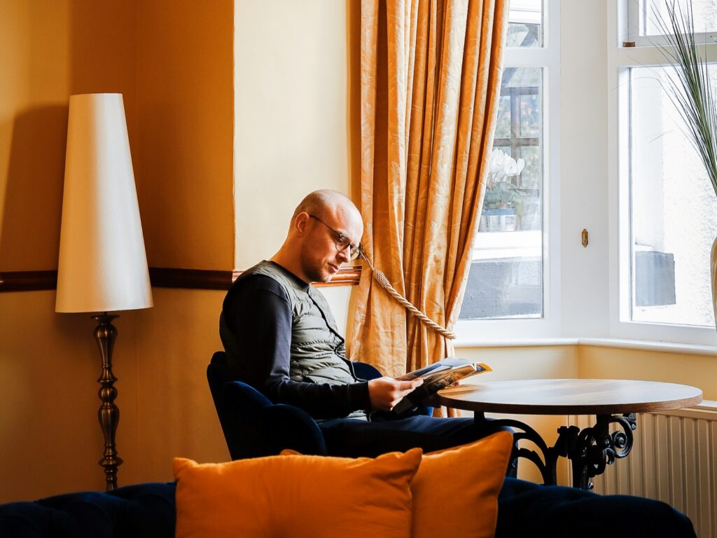 Person reading in a Buttermere Court Hotel room
